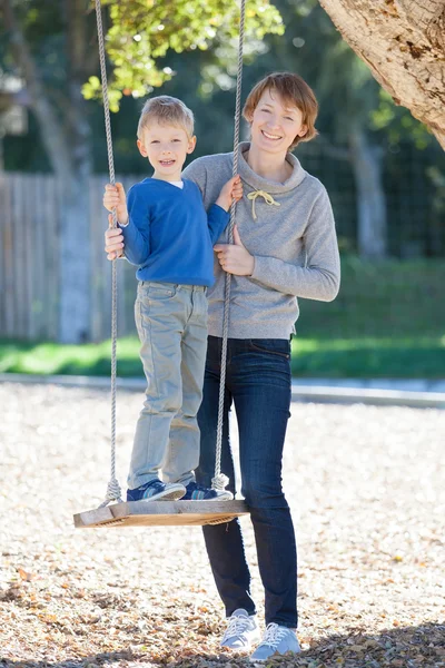 Family at swings — Stock Photo, Image