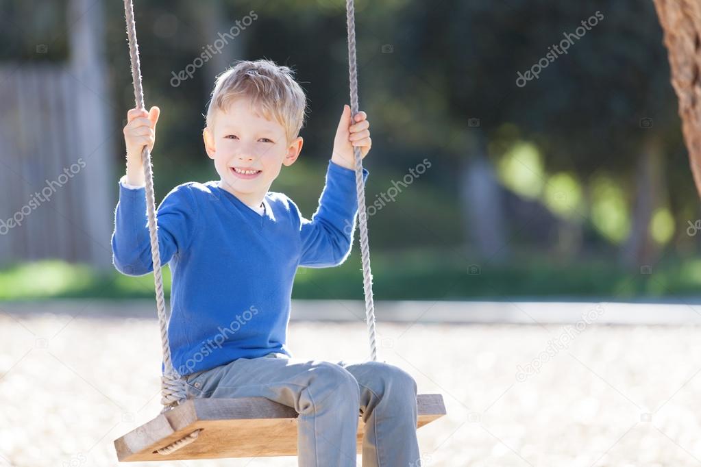 kid swinging at summer