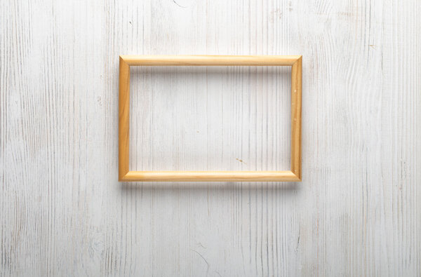 Wooden photo frame on white wall