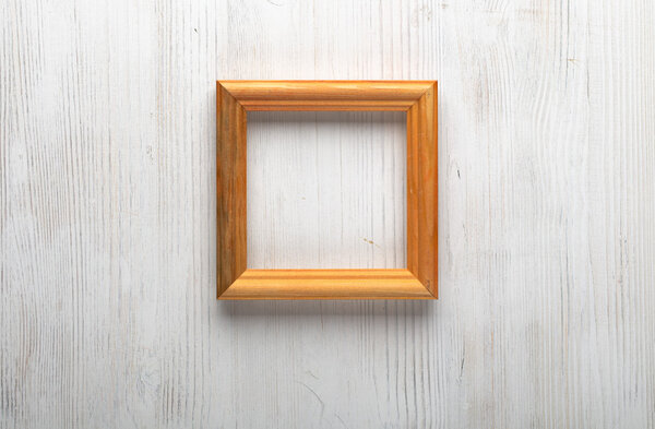 Wooden photo frame on white wall