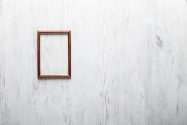 Photo frame on white wall — Stock Photo, Image