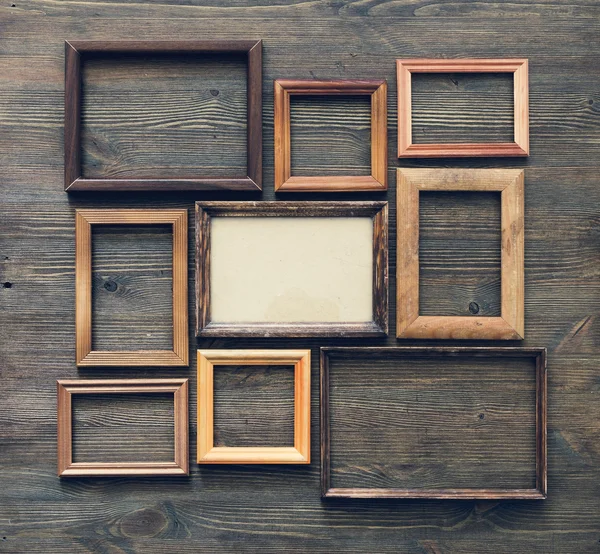 Frames on wooden wall — Stock Photo, Image