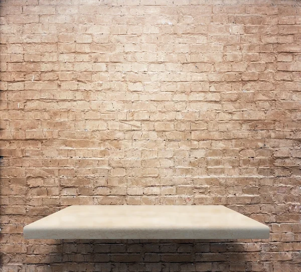 Empty shelves on brick wall — Stock Photo, Image