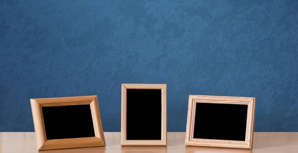Wooden Photo Frames Table Blue Wall — Stock Photo, Image