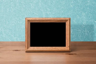 Masada ahşap fotoğraf çerçevesi, mavi duvar.