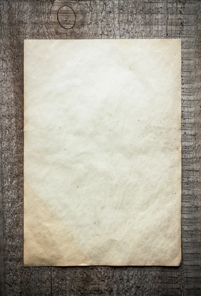 Paper on wooden background — Stock Photo, Image