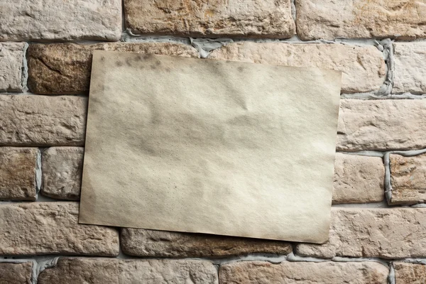 Old paper on wall — Stock Photo, Image