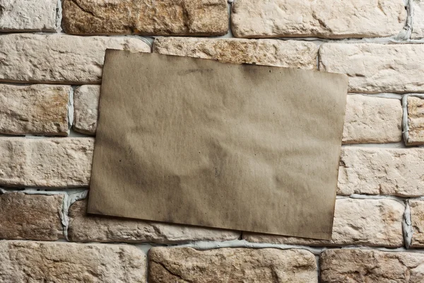 Old paper on wall — Stock Photo, Image