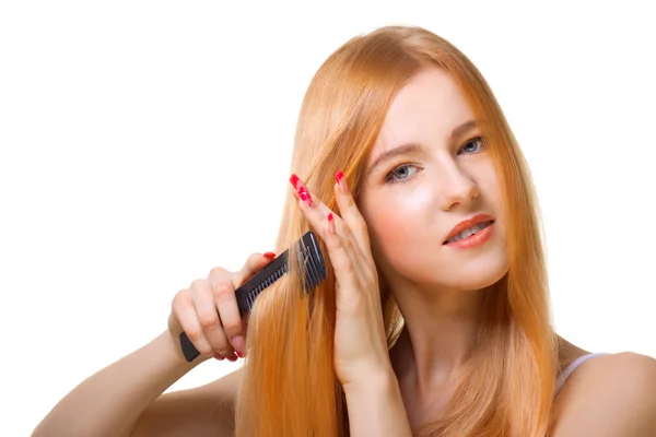 Redhead girl brushing hair — Stock Photo, Image