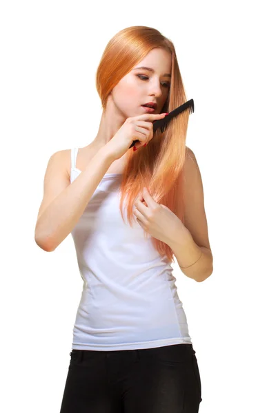 Redhead girl brushing hair — Stock Photo, Image