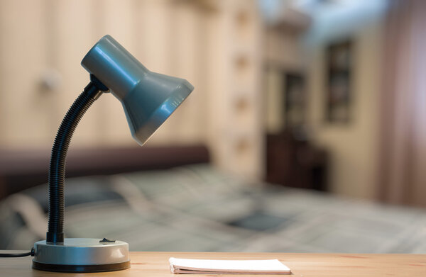 lamp and notebook on table 