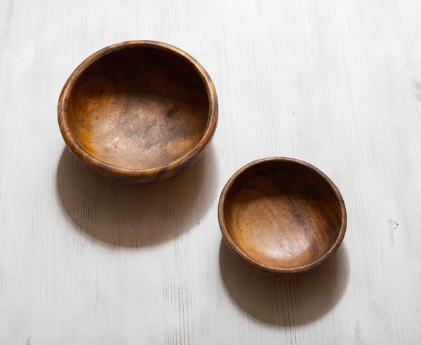 Wooden bowls on white table — Stock Photo, Image