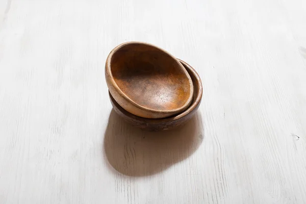 Wooden bowls on white table — Stock Photo, Image