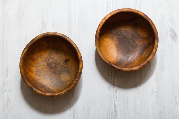 Wooden bowls on white table — Stock Photo, Image