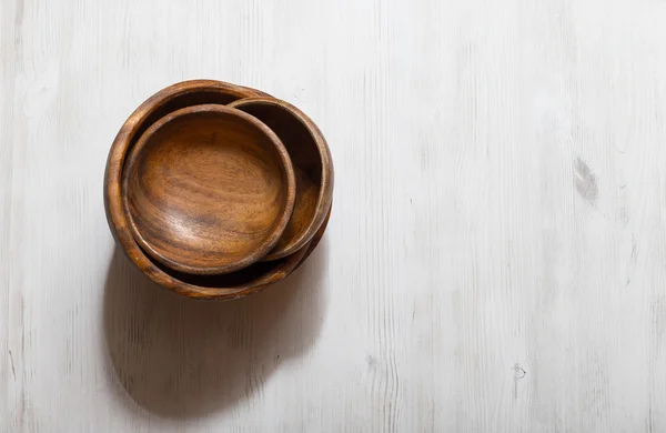 Wooden bowls on white table — Stock Photo, Image