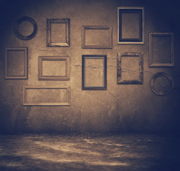 Grunge room with wooden frames — Stock Photo, Image