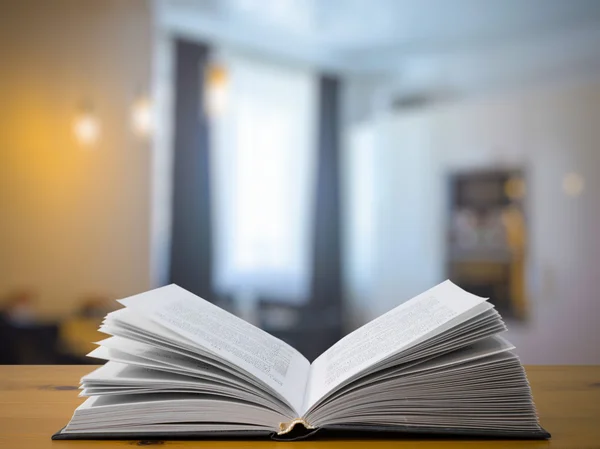 Open book on wooden table — Stock Photo, Image