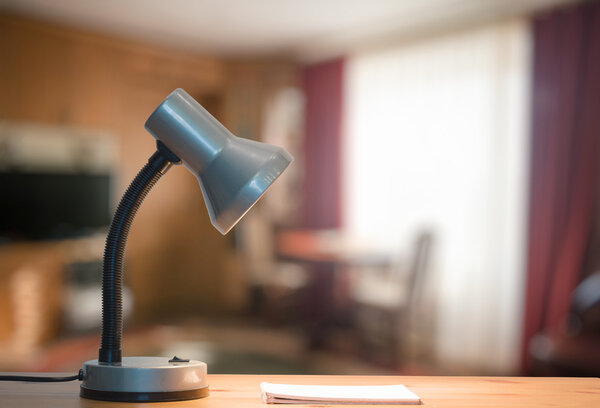 lamp and notebook on table