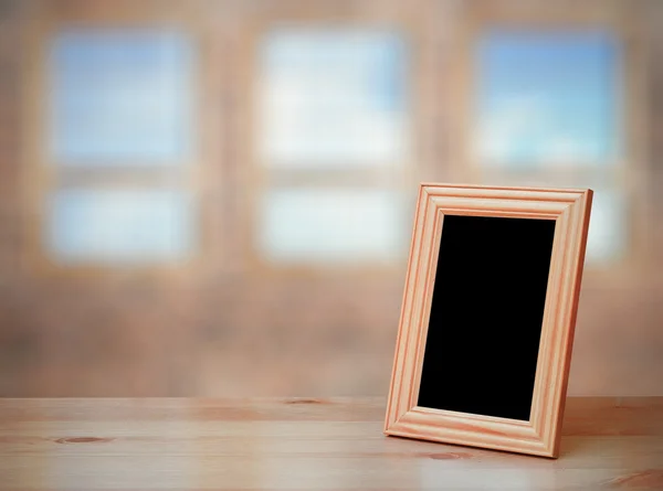 Moldura da foto na mesa de madeira — Fotografia de Stock