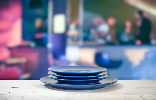 Plates on white table — Stock Photo, Image
