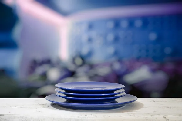 Plates on white table — Stock Photo, Image