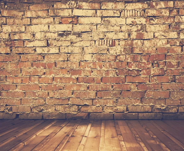 Grunge interior with brick wall — Stock Photo, Image