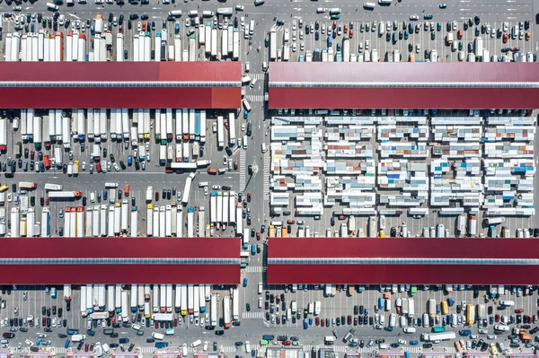 wholesale farmers market. many trucks at warehouse docks. birds eyes view.