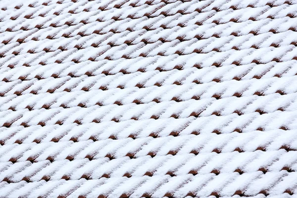 red tile roof with snow