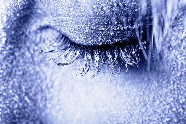 Frozen woman's eye covered in frost clipart