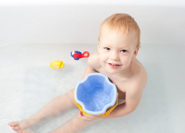 Baby in bath with toys clipart
