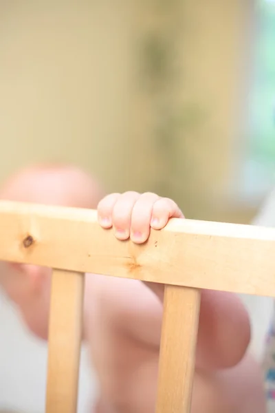 赤ちゃんベッド手で格子を保持します。 — ストック写真