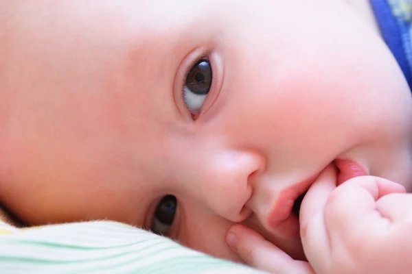 Baby 's face looks at camera close up — стоковое фото