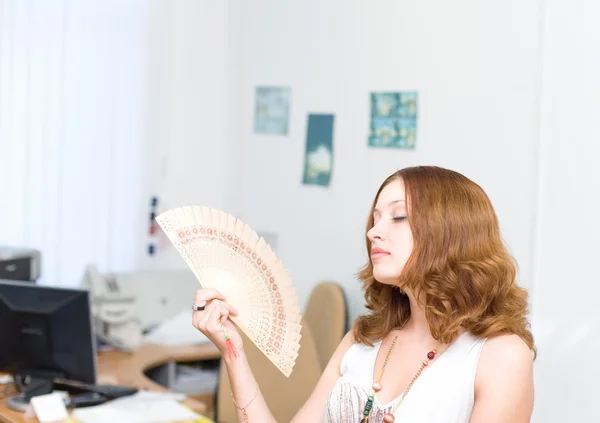 Girl brush away face by fan — Stock Photo, Image