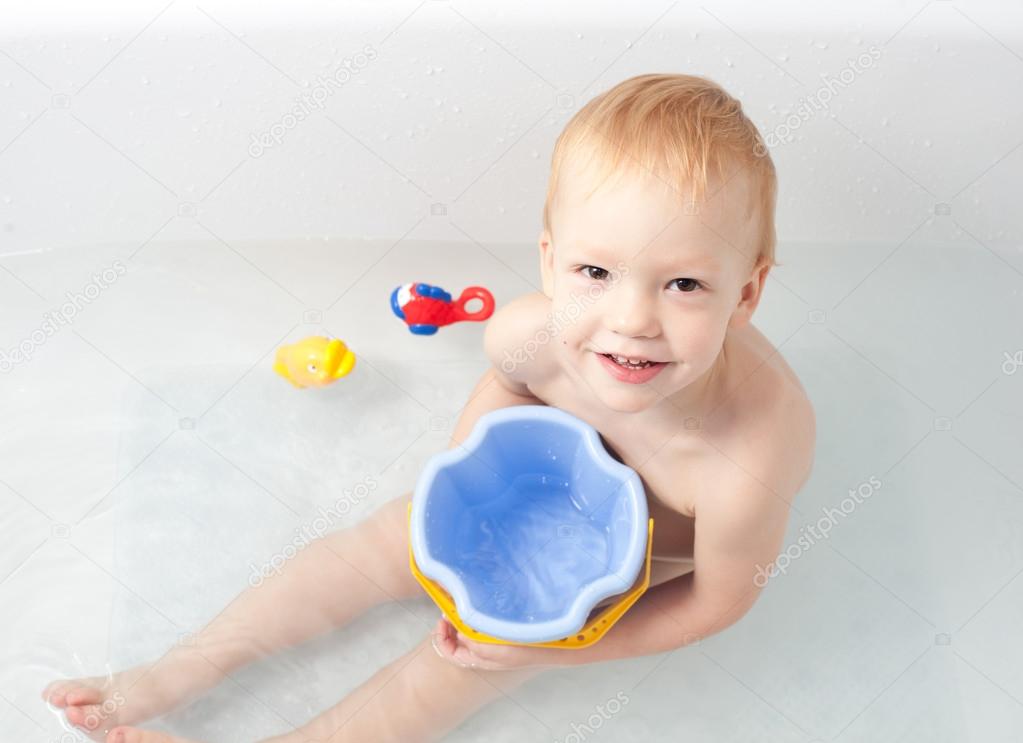 Baby in bath with toys