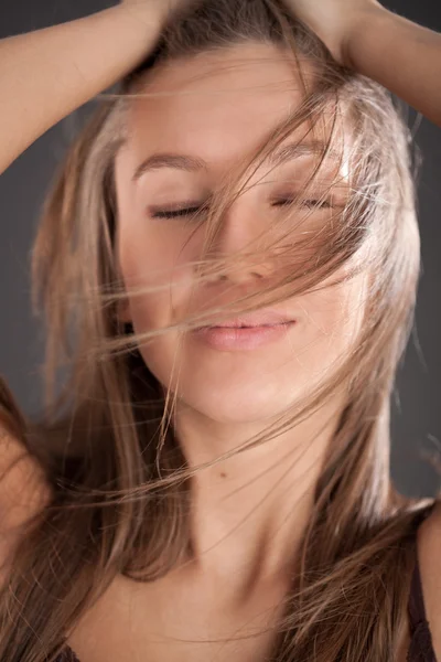 Portrait of pleasured girl holding your hair — Stock Photo, Image