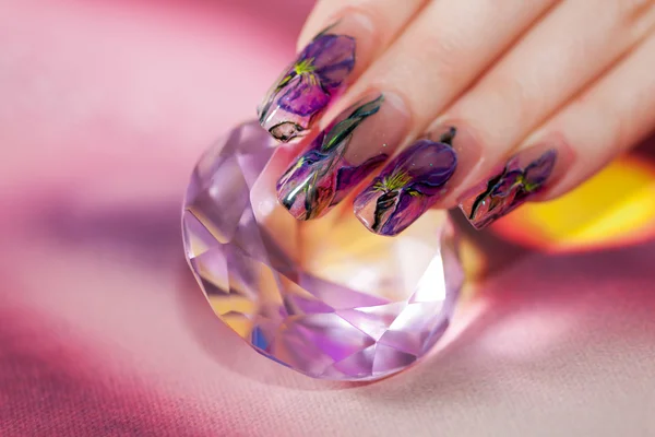 Fingers with  beautiful manicure touch a shining diamond — Stock Photo, Image