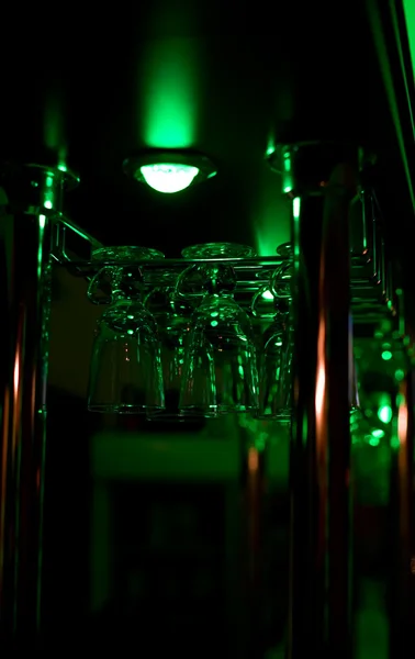 Glasses hang above a bar — Stock Photo, Image