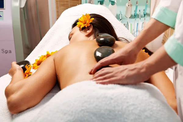 Stone therapy. Woman getting a hot stone massage in spa salon — Stock Photo, Image