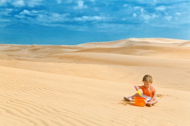 İki yıl çalınıyor'eski bebek kız bir çöl gibi büyük kum havuzunda