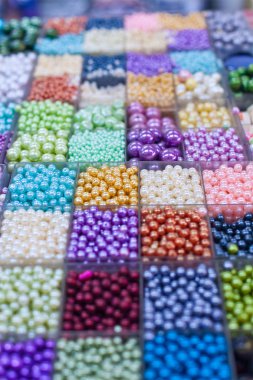 Beads in boxes on a Thai sunday market Chatuchak clipart