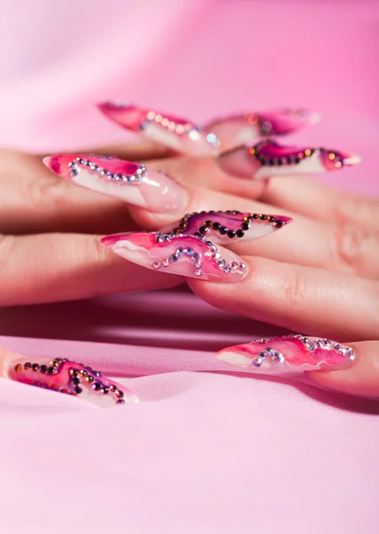 Human fingers with long fingernail over pink — Stock Photo, Image