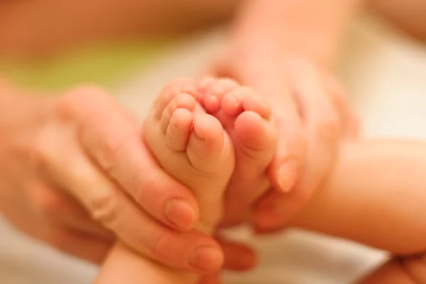 Mother gently massage baby — Stock Photo, Image