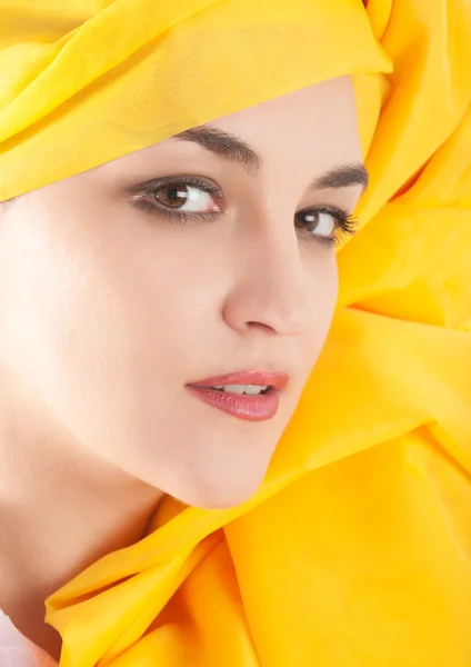 Woman covering in yellow cloth — Stock Photo, Image