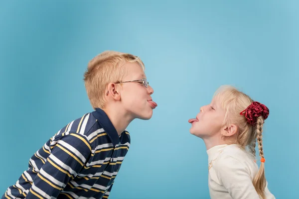 十几岁的男孩和女孩伸出舌头互相 — 图库照片