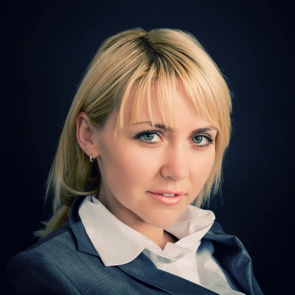 Young smiling woman in a business suit — Stock Photo, Image