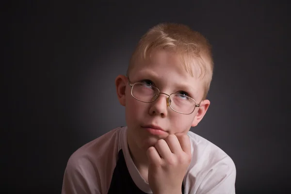 Boy look up and prop his head by hand — Stock Photo, Image