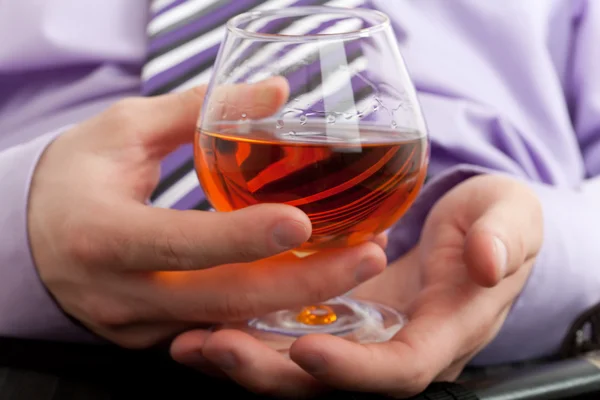 Hand with glass of cognac — Stock Photo, Image