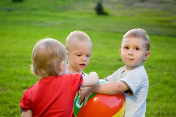 Trois petits garçons jouent avec la balle — Photo