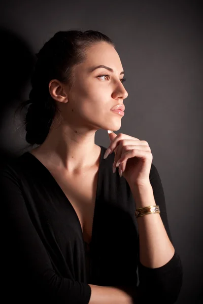 Portrait of attractive brunette girl over black — Stock Photo, Image