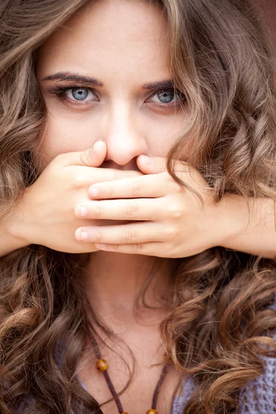 Younger sister closed mouth of her older sister by hands — Stock Photo, Image